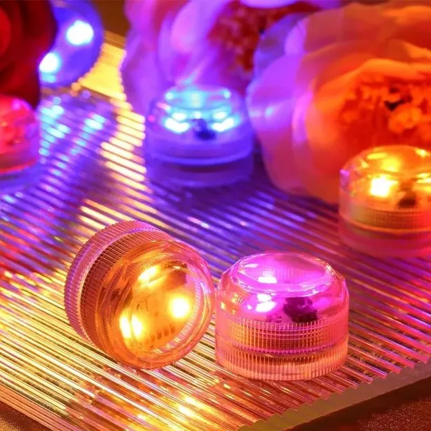 Colorful cosmetic jars lit by bright led lights on a reflective striped surface creating a vibrant display