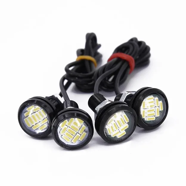 Four small round led signal lights on black housings with wired harnesses ready for installation on a vehicle